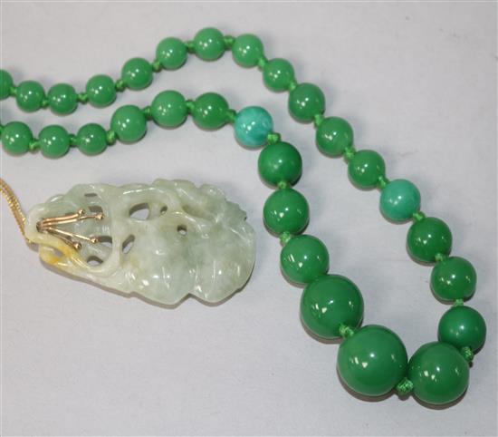 A carved jadeite pendant on a 9ct gold chain and a set of green glass beads.